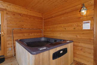 The outdoor hot tub is enclosed, and has a view of the wooded surroundings that Cuddler's Paradise has to offer